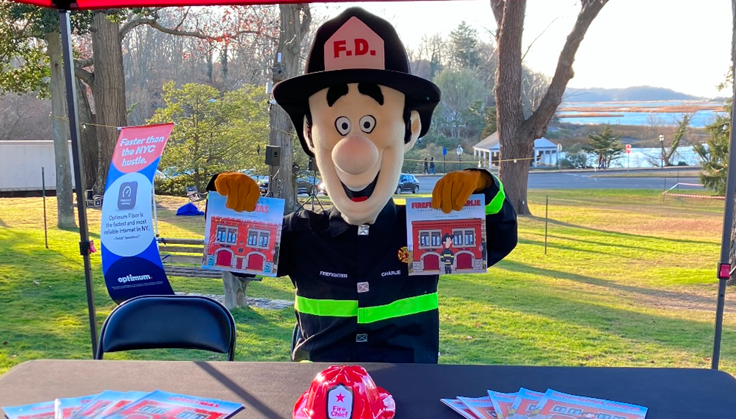 Fire department mascot holding children's books